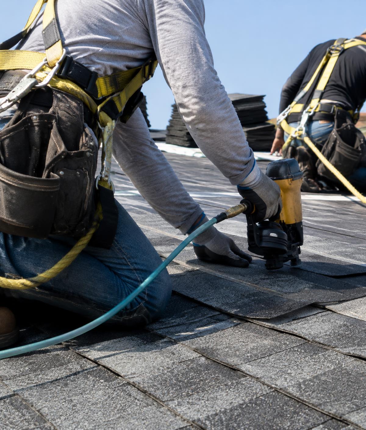 Roofers installing shingles (representative stock image)
